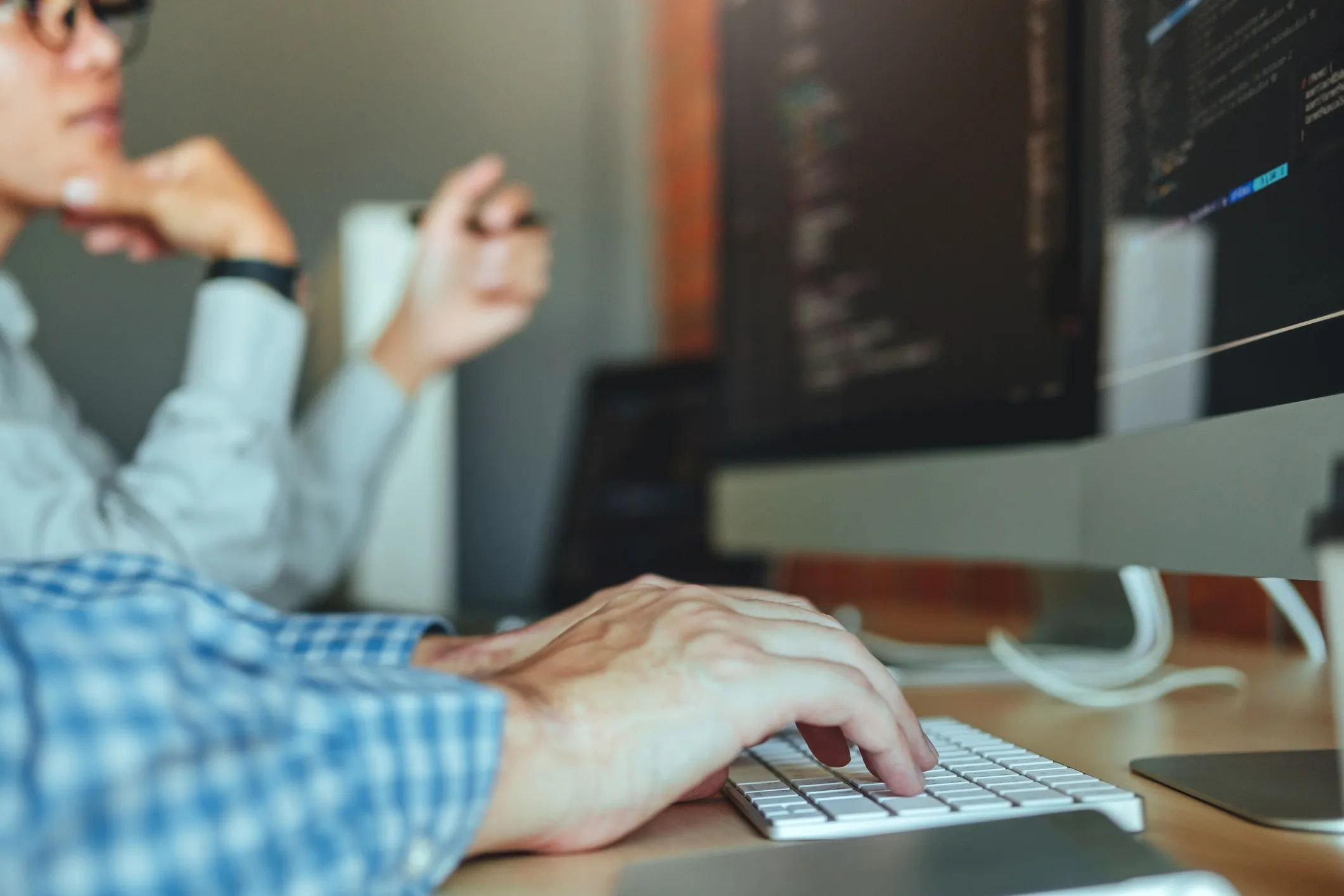 Two engineers pair programming at a desk